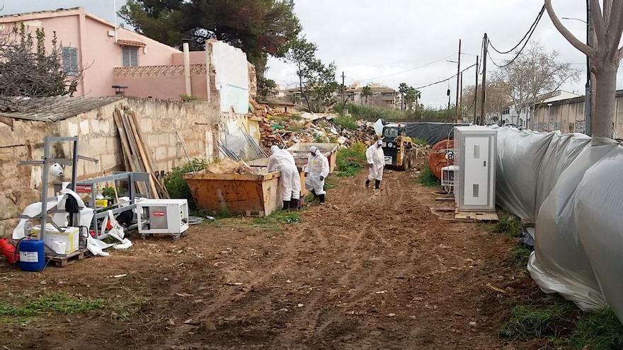 Operarios trabajan retirando el amianto en la calle Aragó.