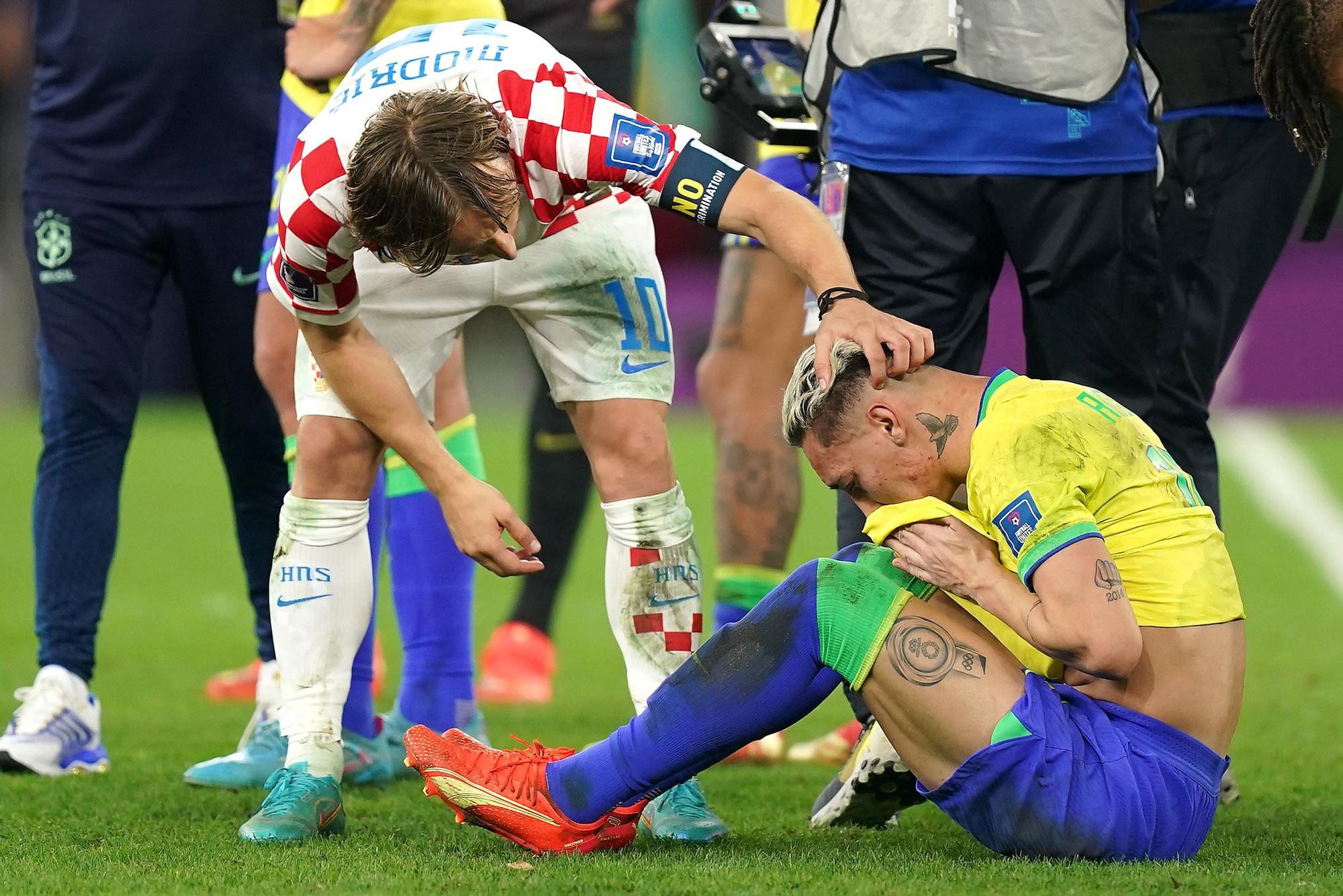 Brazil's Antony (R) is consoled by Croatia's Luka Modric after the penalty shoot-out of the FIFA World Cup Qatar 2022 Quarter-Final soccer match between Croatia and Brazil at the Education City Stadium in Al Rayyan.