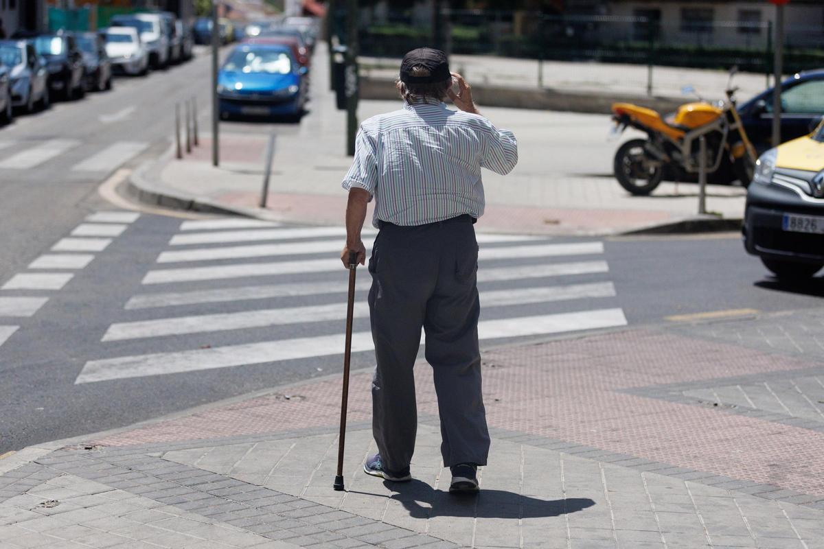 Un hombre mayor pasea apoyándose en un bastón.
