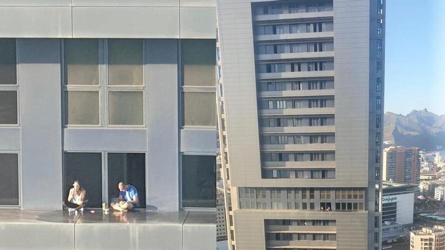 Una pareja come en el saliente de una de las Torres de Santa Cruz de  Tenerife; a más de 100 metros de altura