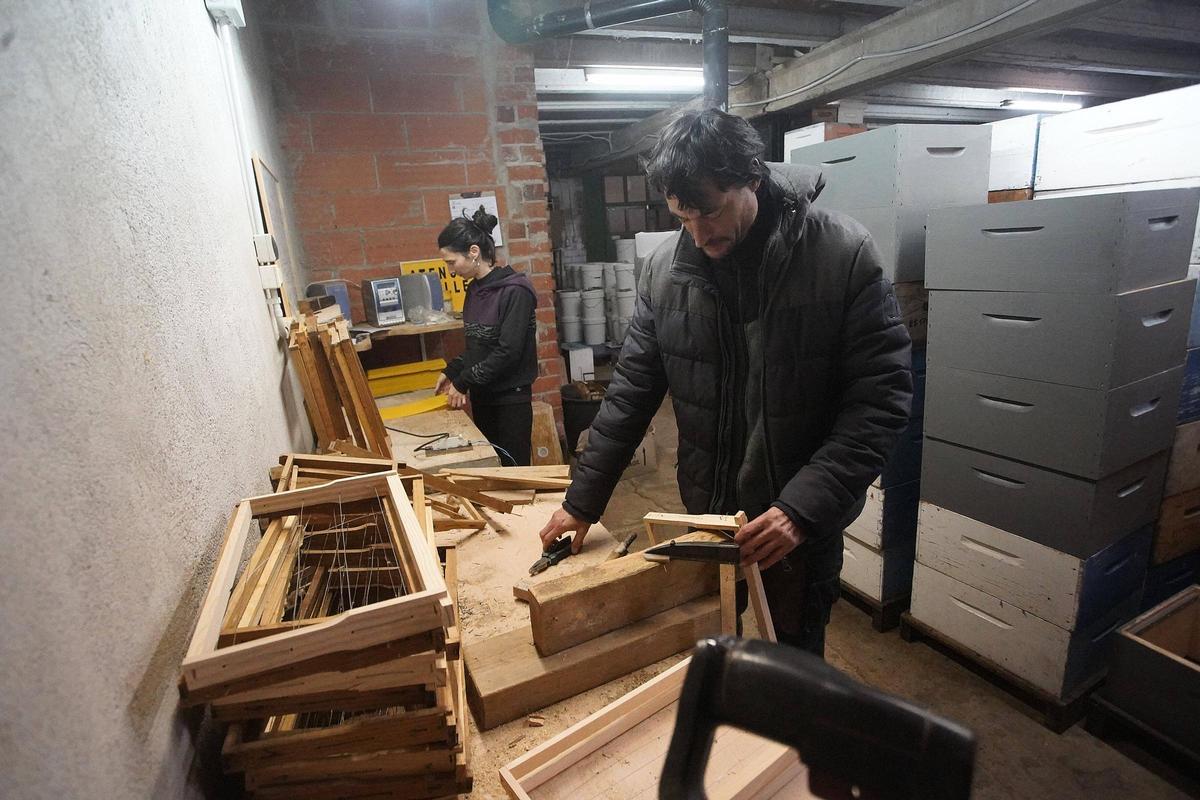Laura i Sergi al seu taller de Crespià preparant els quadres de cera per a un cicle de producció de mel.