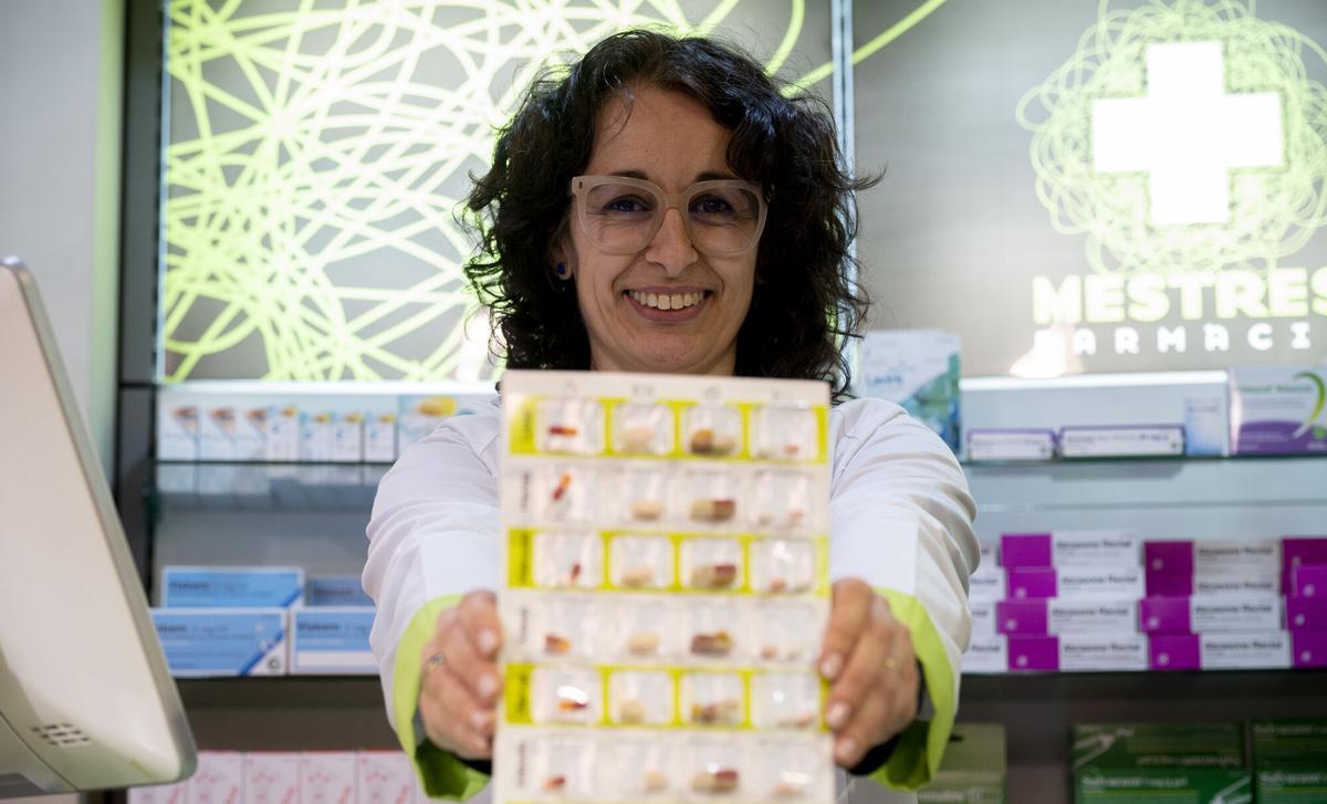El Vendrell (Barcelona) . 26.01.2026. Sociedad Carme Mestres Català, famacéutica, fotografiada mostradndo un SPD ( sistema personalizado de dosificación ), en su farmacia de El Vendrell. Fotografía de Jordi Cotrina