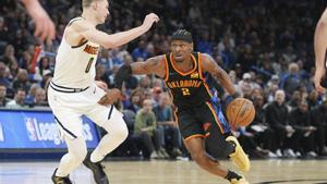 Oklahoma City Thunder guard Shai Gilgeous-Alexander (2) drives past Denver Nuggets guard Christian Braun (0) during the second half of an NBA basketball game, Sunday, March 9, 2025, in Oklahoma City. (AP Photo/Kyle Phillips)