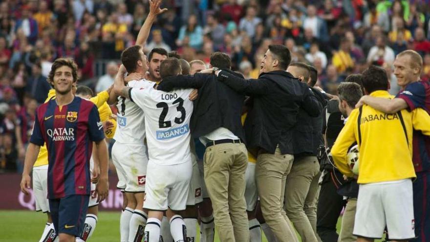 Los jugadores del Deportivo celebran la permanencia en el Camp Nou la pasada temporada ante Sergi Roberto.