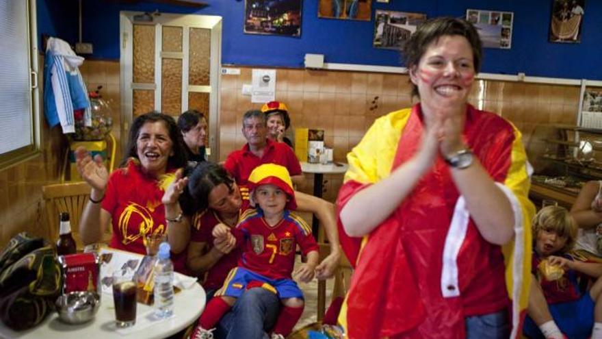 Varios aficionados celebran el primer gol de Xabi Alonso en la confitería-bar Carly.