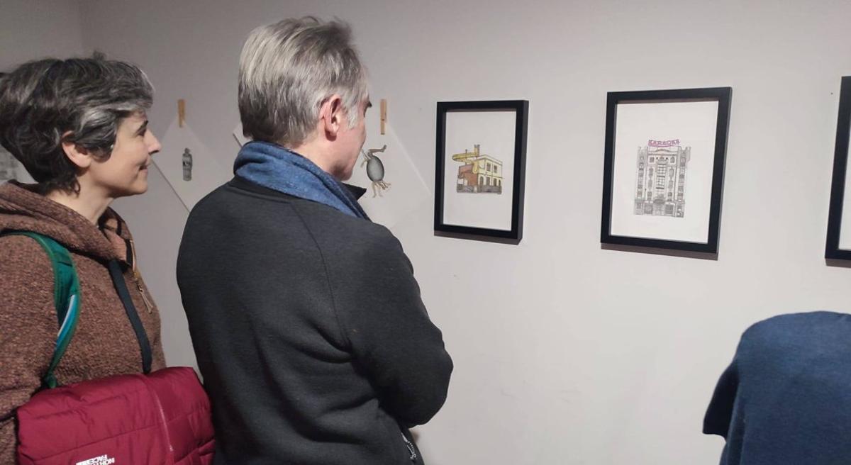 Los visitantes observan los cuadros de la exposición «Dis-tópicas urbanas». | B. B.