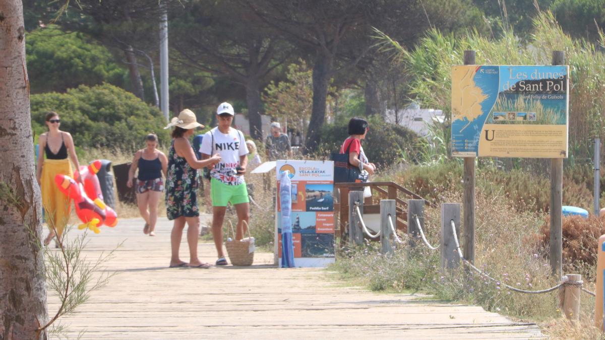 Uns turistes a la platja de Sant Pol a Sant Feliu de Guíxols