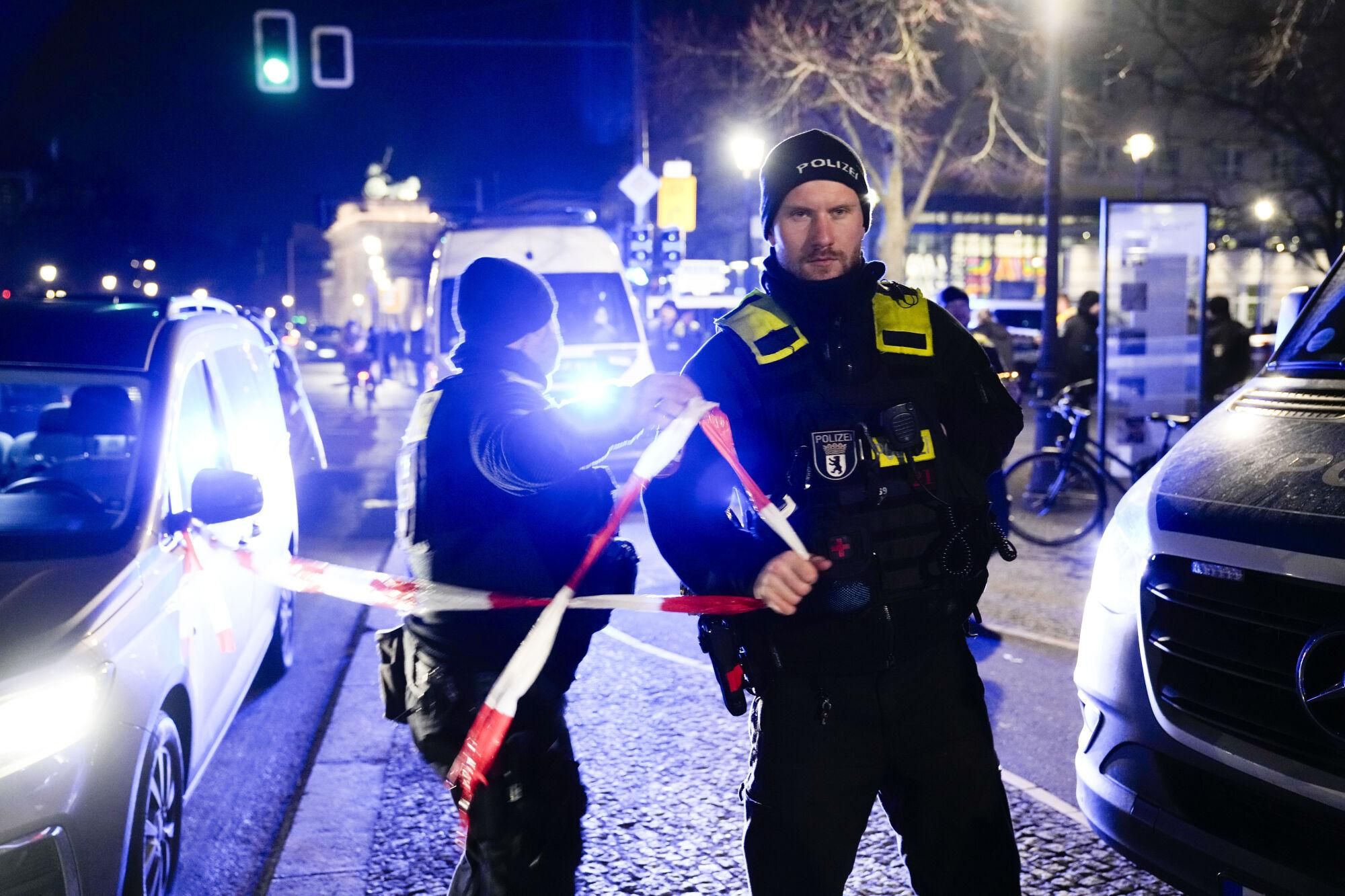 Police officers attend the scene at the Holocaust memorial after a man was attacked at the memorial site in Berlin, Germany, Friday, Feb. 21, 2025. (AP Photo/Ebrahim Noroozi)