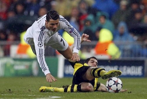 Ronaldo of Real Madrid falls over Mkhitaryan of Borussia Dortmund during their Champions League quarter-final first leg soccer match at Santiago Bernabeu stadium in Madrid