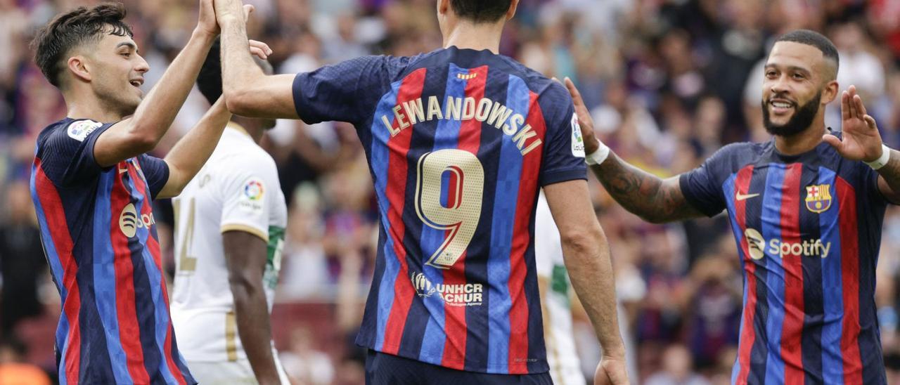 Lewandowski celebra el segon gol amb Pedri i Memphis. | EFE/QUIQUE GARCÍA