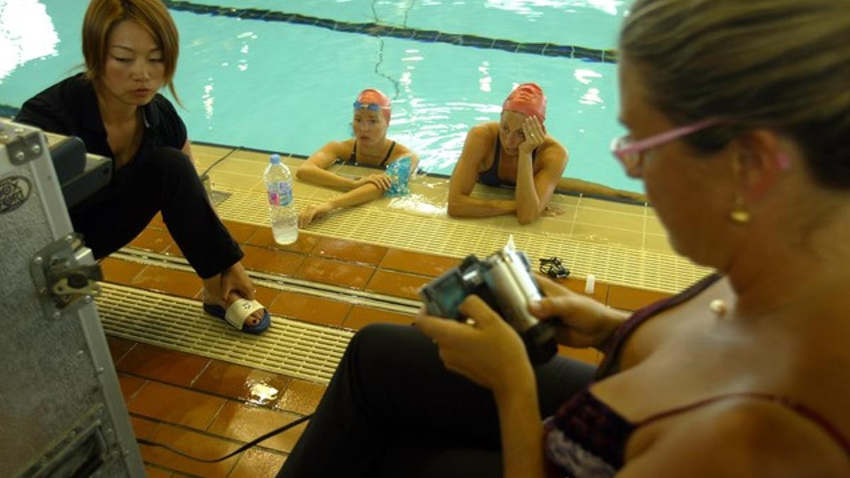 Paola Tirados (izquierda dentro del agua) y Gemma Mengual, a su lado, junto a Anna Tarrés (con videocámara), durante un entreno.