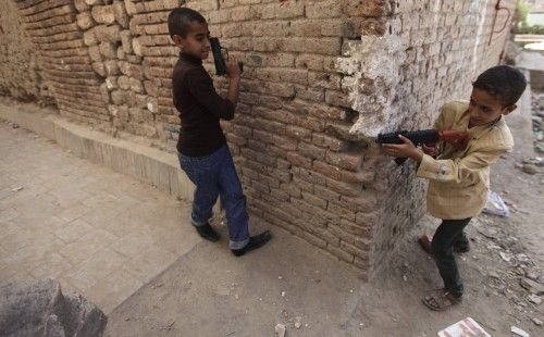 Children play with toy guns during Eid al-Adha in Sanaa