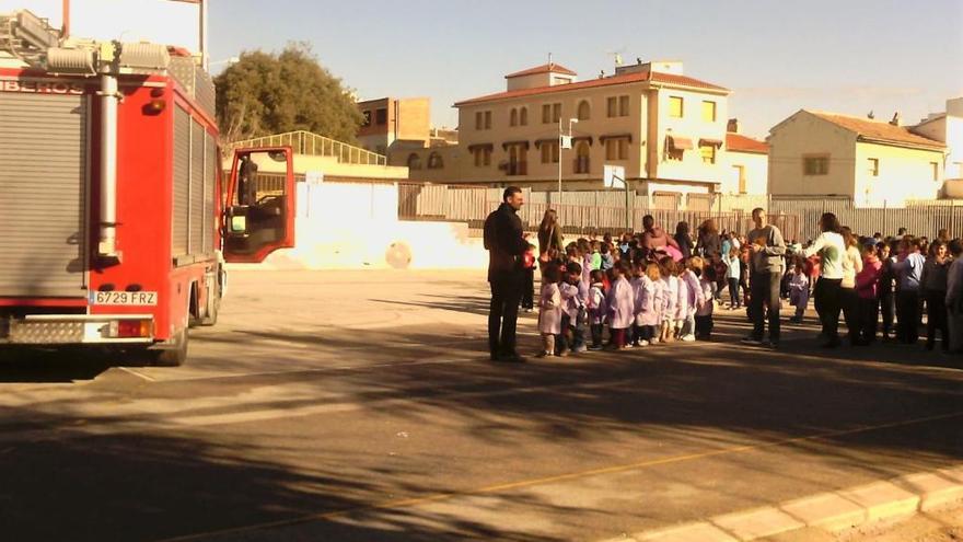 Bomberos y alumnos durante la evacuación