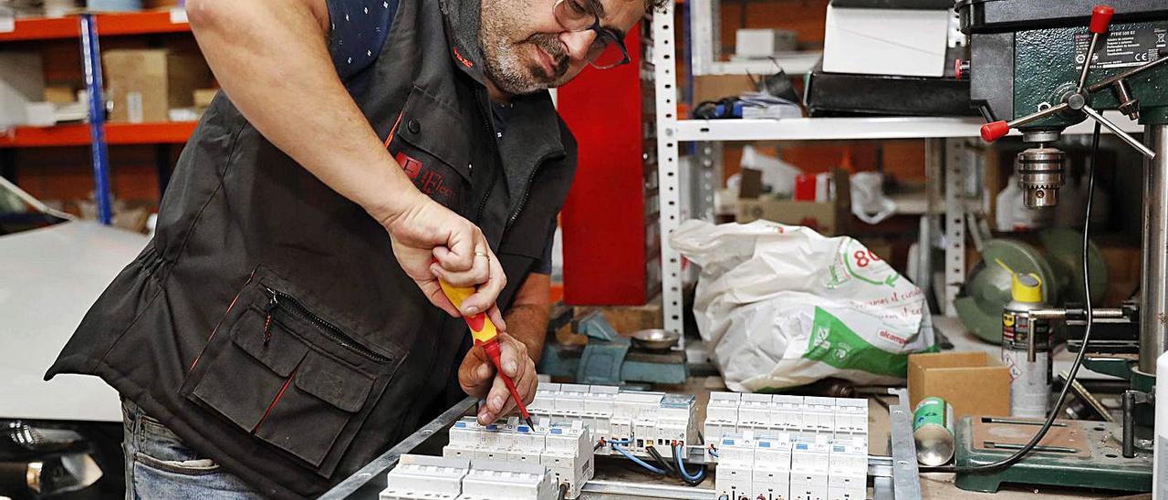 Francisco Piñeiro repara
un cuadro eléctrico en su 
taller de Electronavia.   | // P.H.