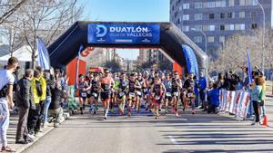 Corredores cruzando el arco de la carrera Duatlón Popular Villa de Vallecas en una edición anterior