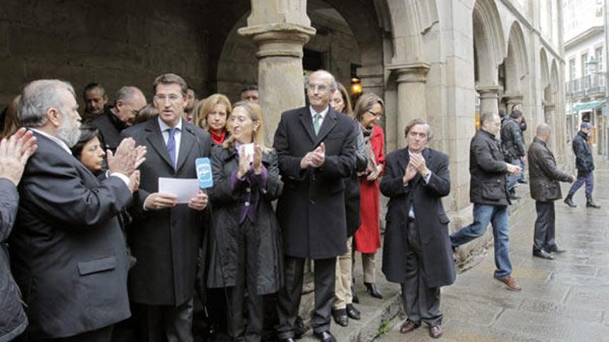 El presidente de la Xunta y líder del PPdeG, Alberto Núñez Feijóo (3, izq), tras su intervención en el Pleno del Parlamento regional, con los diputados y senadores electos de su partido, esta mañana en el casco histórico de Santiago de Compostela.