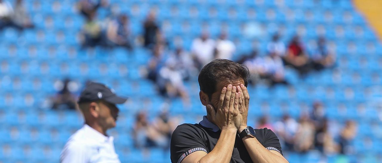 Sergio Mora prefiere no mirar lo que sucede sobre el césped después de otro fallo del Hércules con Miguel Rivera en segundo plano.