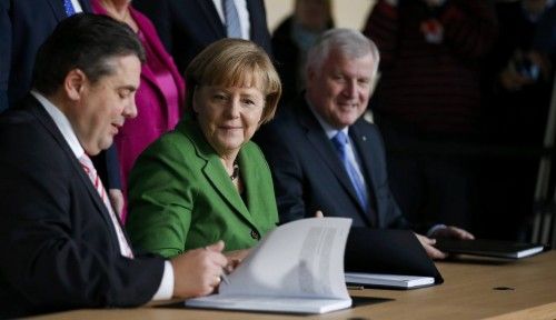 Party leaders German Chancellor Merkel of the CDU, Seehofer of the CSU and Gabriel of SPD sign a preliminary agreement, which has still to be approved by the members of the SPD, in the Bundestag in Berlin