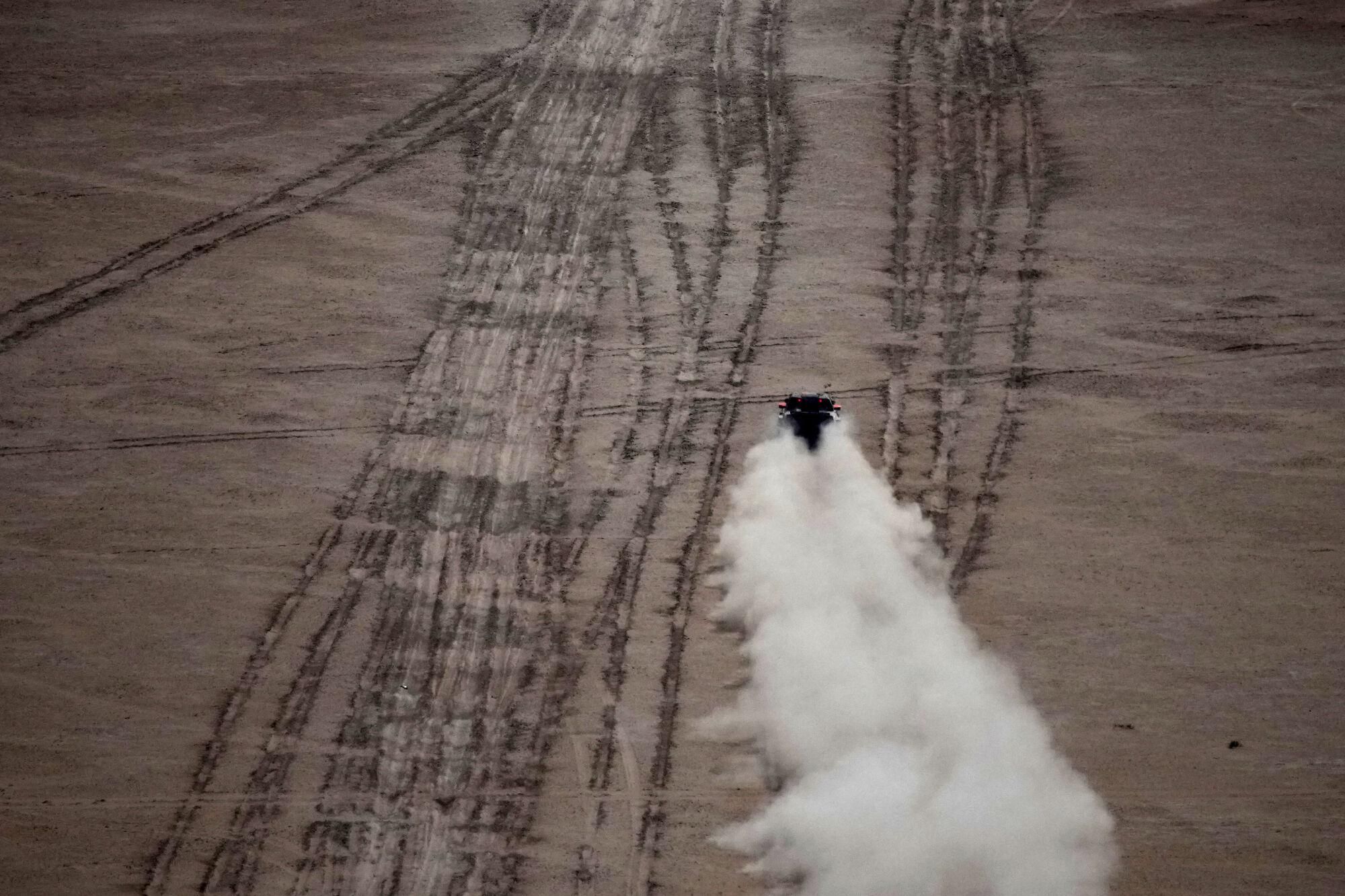 A car drives during the seventh stage of the Dakar Rally with start and finish in Al Duwadimi, Saudi Arabia, Sunday, Jan. 12, 2025. (AP Photo/Christophe Ena). EDITORIAL USE ONLY/ONLY ITALY AND SPAIN