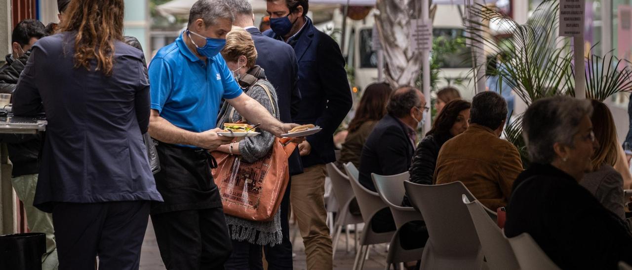 Un camarero atiende a los clientes de una terraza de Santa Cruz de Tenerife.