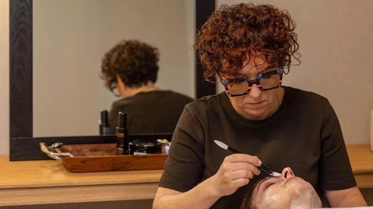 Ana Mancebo da un masaje facial a una clienta en su salón de Negreira.