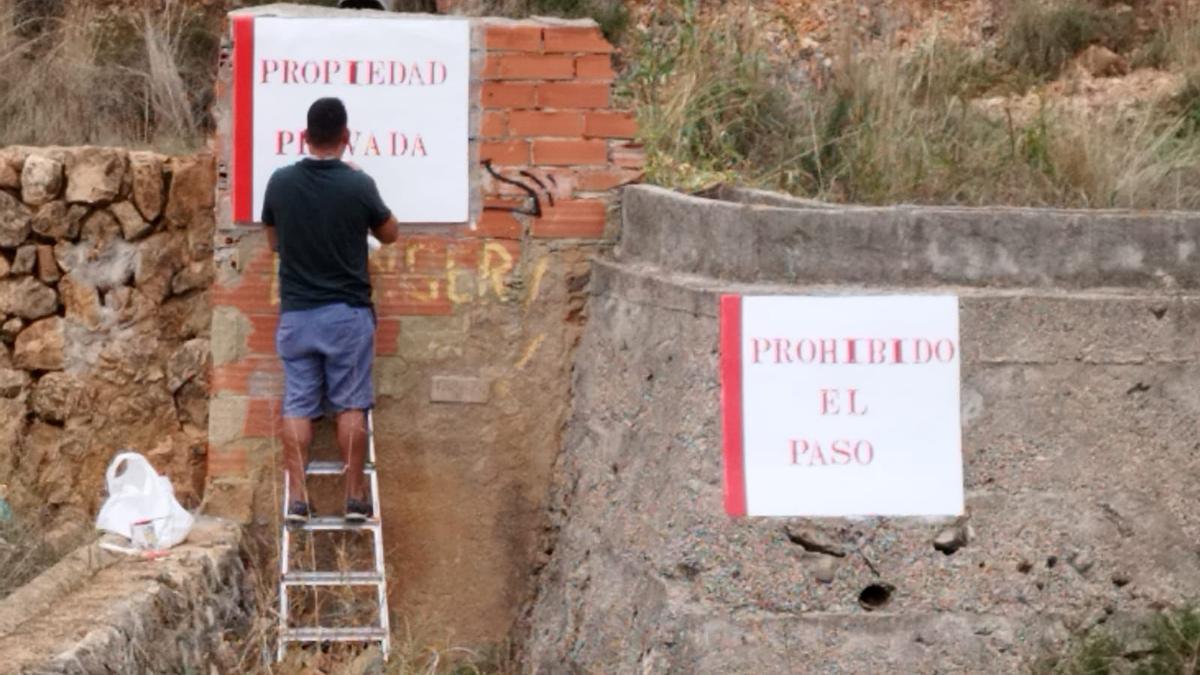 Los carteles que prohíben el paso a la Penya Roja de Gandia.