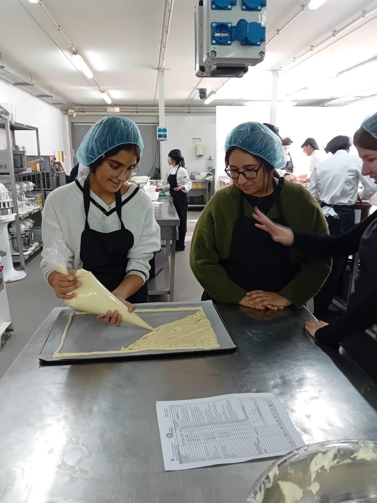 Dues alumnes treballant a l'obrador de l'Escola d'Hostalaria de Figueres.