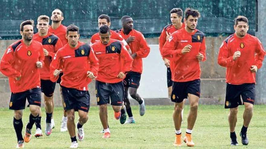 Los jugadores del Mallorca entrenan en la sesión del viernes bajo la lluvia.