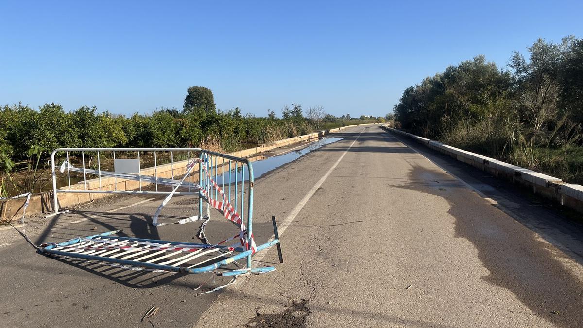 La valla que la Policía Local había puesto para cortar el inundado camí Cabeçol, retirada por algún conductor para poder pasar.