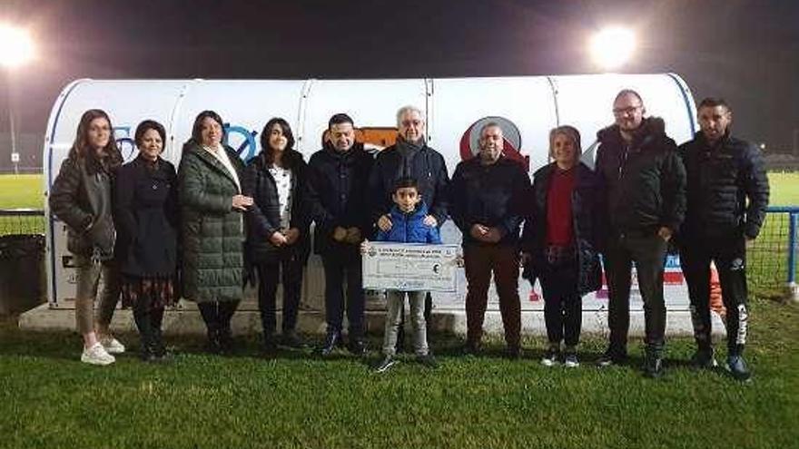 La simbólica entrega del cheque a Hugo y su familia. // FdV