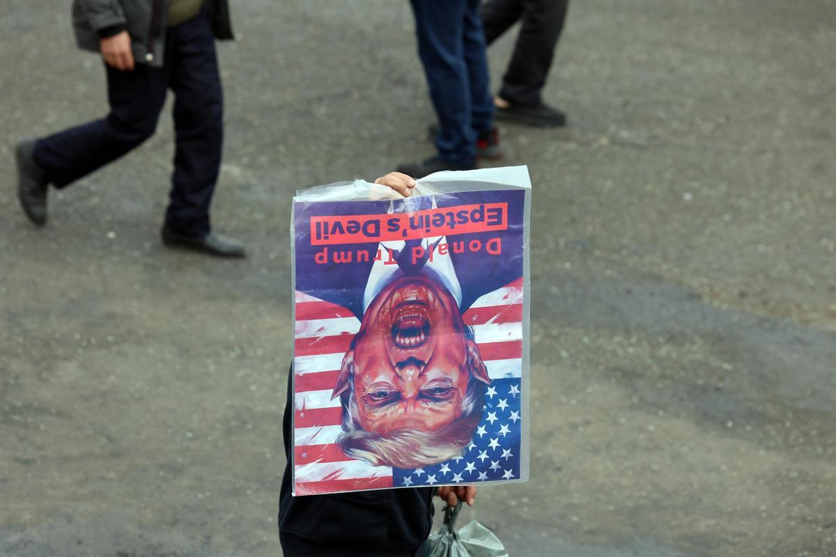 Un manifestante iraní nuestra una imagen Trump durante el funeral por Esmail Jatib, ministro de Inteligencia de Irán, muerto en un ataque israelí.