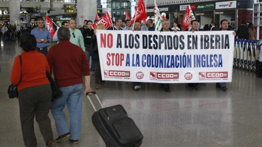 Un viajero se cruza con los trabajadores de Iberia.