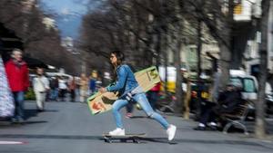 Gisela Pulido cruza la Rambla de Catalunya de Barcelona sobre un monopatín con su inseparable tabla.