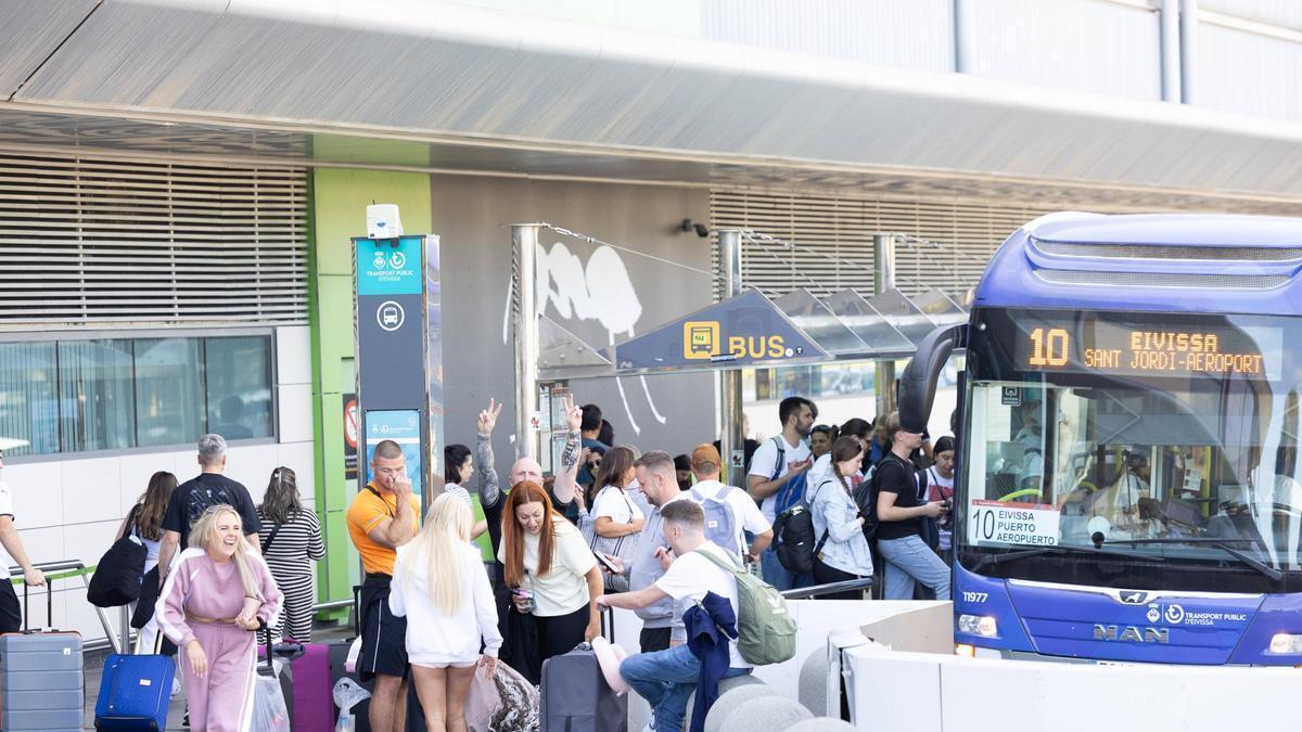 Turistas subiendo a un autobús en el aeropuerto de Ibiza.