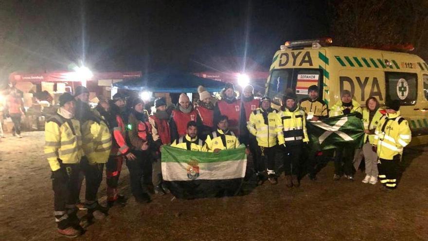 En el campo de refugiados: Juanjo y Pedro (tras la bandera extremeña) junto a otros voluntarios de DYA y de Cáritas en Dorohusk, la noche del miércoles.