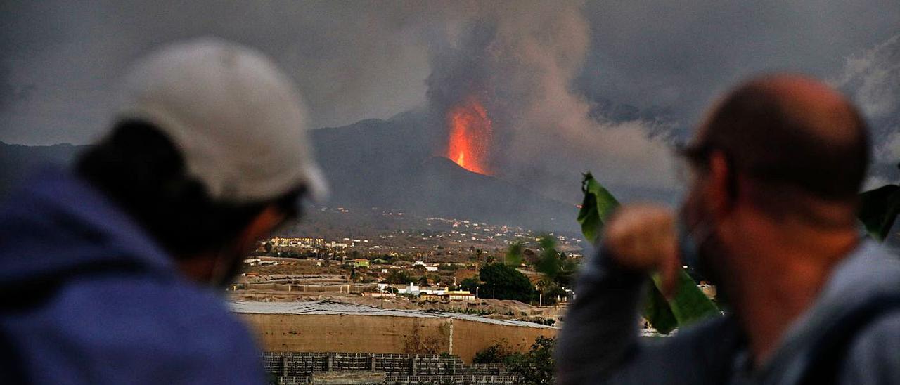 Dos personas miran ayer al volcán de Tajogaite. | | KIKE RINCÓN (EUROPA PRESS)