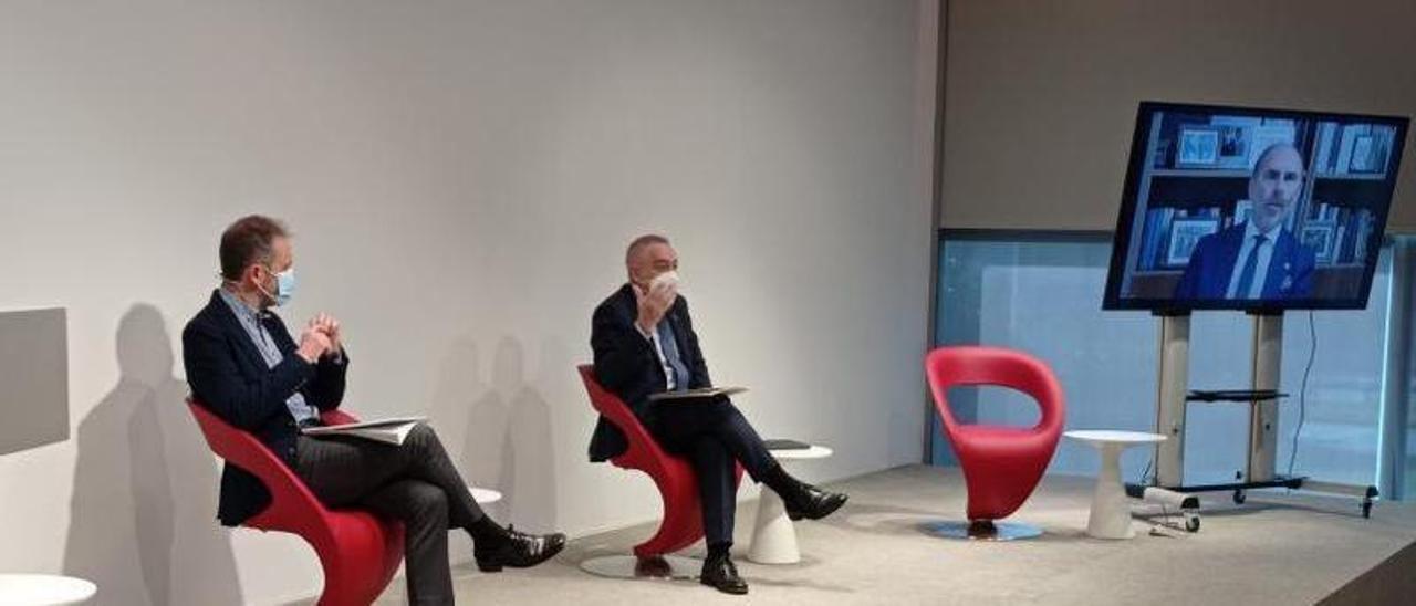Eduardo Álvarez y Pere Navarro en el encuentro celebrado en Barcelona, junto a la pantalla desde la que intervino telemáticamente Ignacio Villaverde.