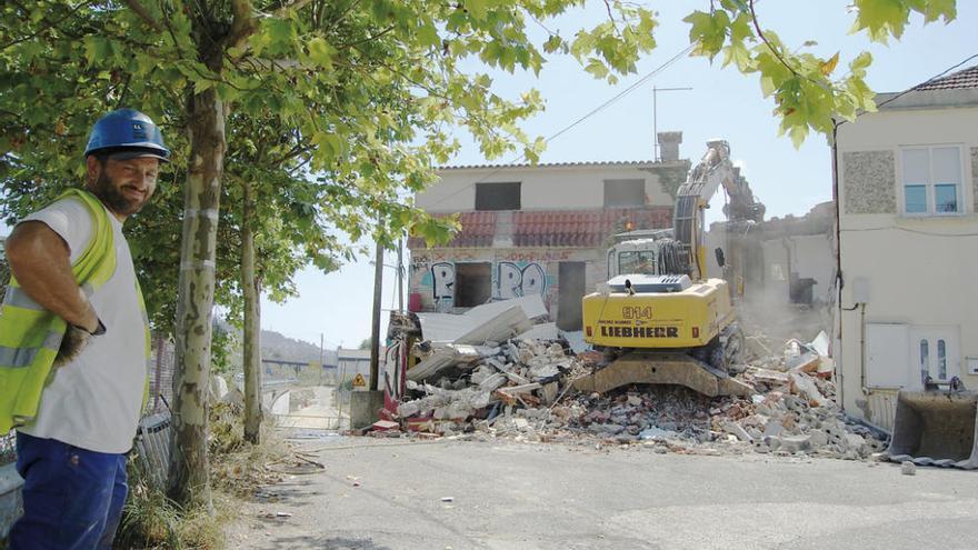 Una máquina derriba una de las casas, ayer, en el Camiño do Torreiro de Chapela.  // FdV
