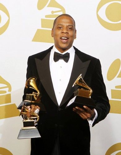 Jay-Z poses with the awards he won at the 55th annual Grammy Awards in Los Angeles