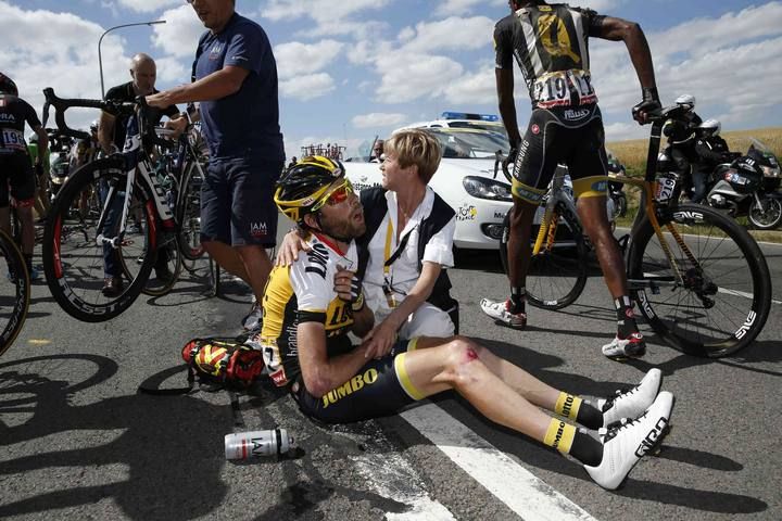 Lotto-Jumbo rider Laurens ten Dam of the Netherlands receives assistance as he sits on the ground after a fall during the third stage of the 102nd Tour de France cycling race from Anvers to Huy
