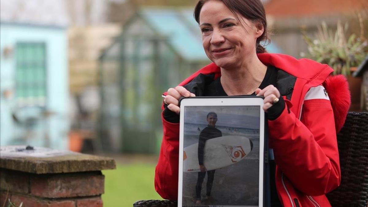 Sally Flavill shows a photograph of her nephew Joseph Flavill  who has awoken from a coma with no knowledge of the coronavirus disease (COVID-19) pandemic after he was injured in a car accident in March 2020  during an interview in Nottingham  Britain  February 5  2021  Picture taken February 5  2021  REUTERS Molly Darlington