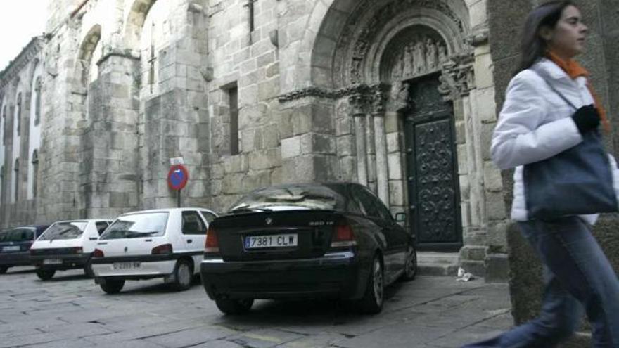 Vehículos estacionados en un lateral de la Colegiata de Santa María del Campo. / casteleiro