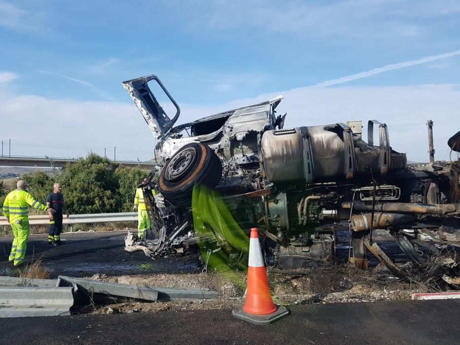 Los bomberos del Parque Comarcal de Elda refrigeran el tráiler que ha volcado y posteriormente se ha incendiado