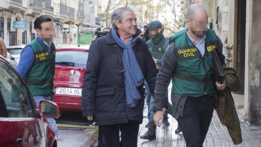 Corbín escoltado por la Guardia Civil durante el registro de su despacho.