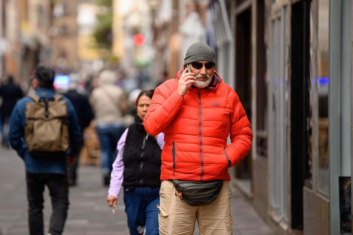 Un hombre pasea por La Laguna abrigado.