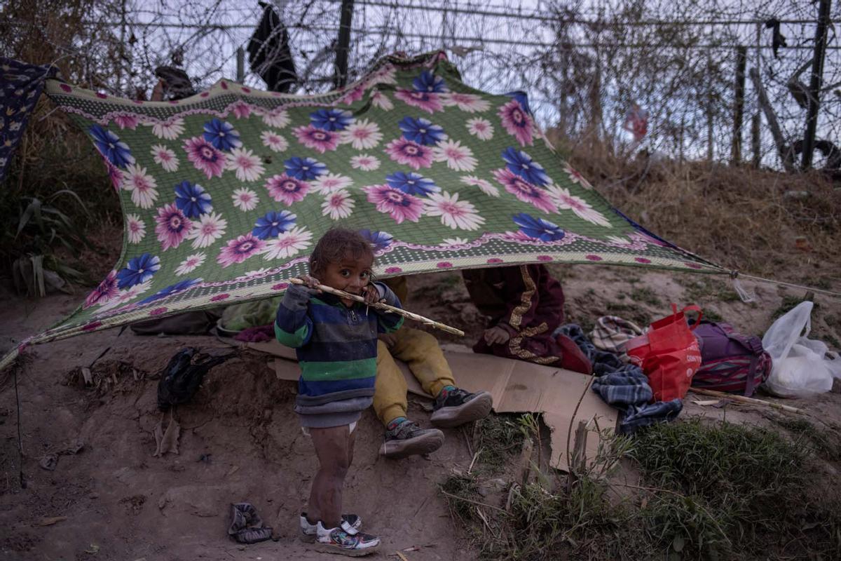 Migrantes acampan a lo largo de la orilla del río Grande mientras esperan entregarse a las autoridades de inmigración en El Paso, Texas, EE.UU