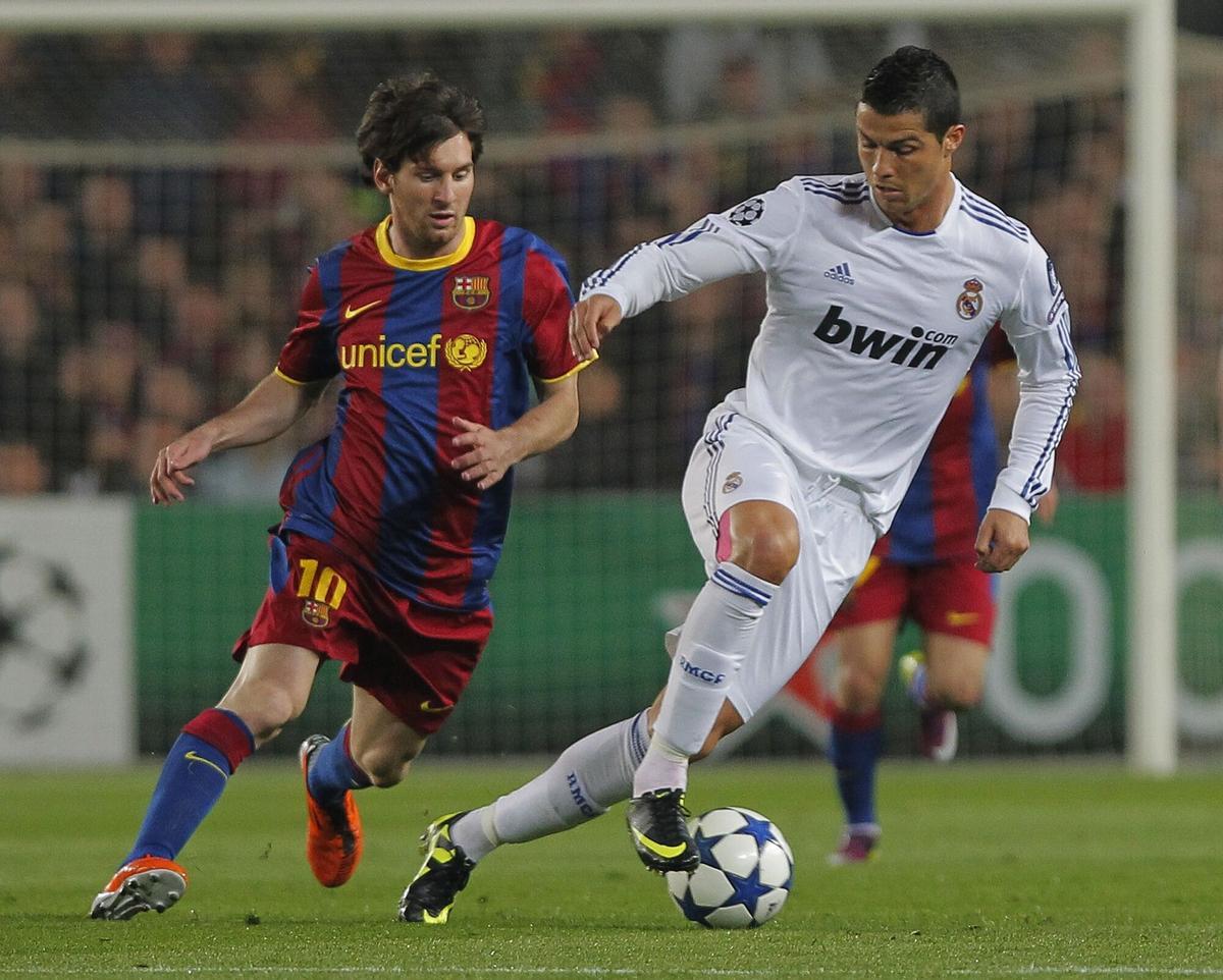 FILE - FC Barcelona's Lionel Messi from Argentina, left, vies for the ball Real Madrid's Cristiano Ronaldo from Portugal, right, during a semi final, 2nd leg Champions League soccer match at the Camp Nou stadium in Barcelona on Tuesday, May 3, 2011. (AP Photo/Andres Kudacki, File). FILE PHOTO