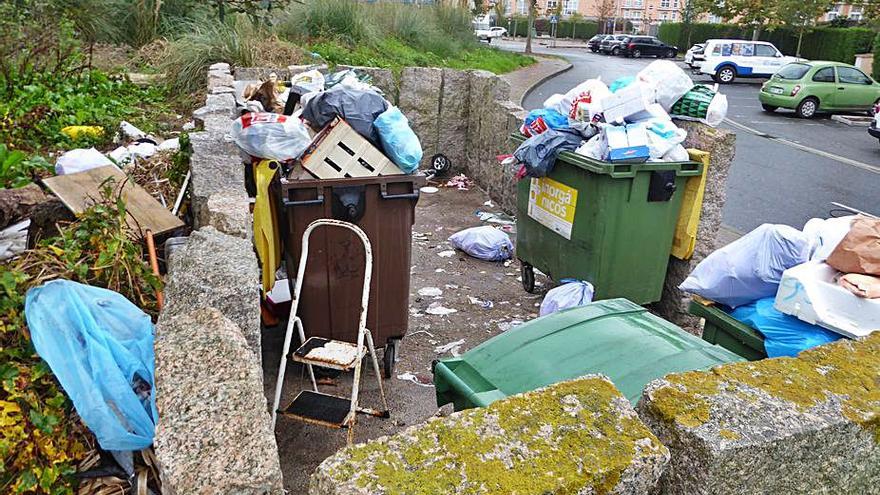 Residuos depositados fuera de unos contenedores.   | // I. R.