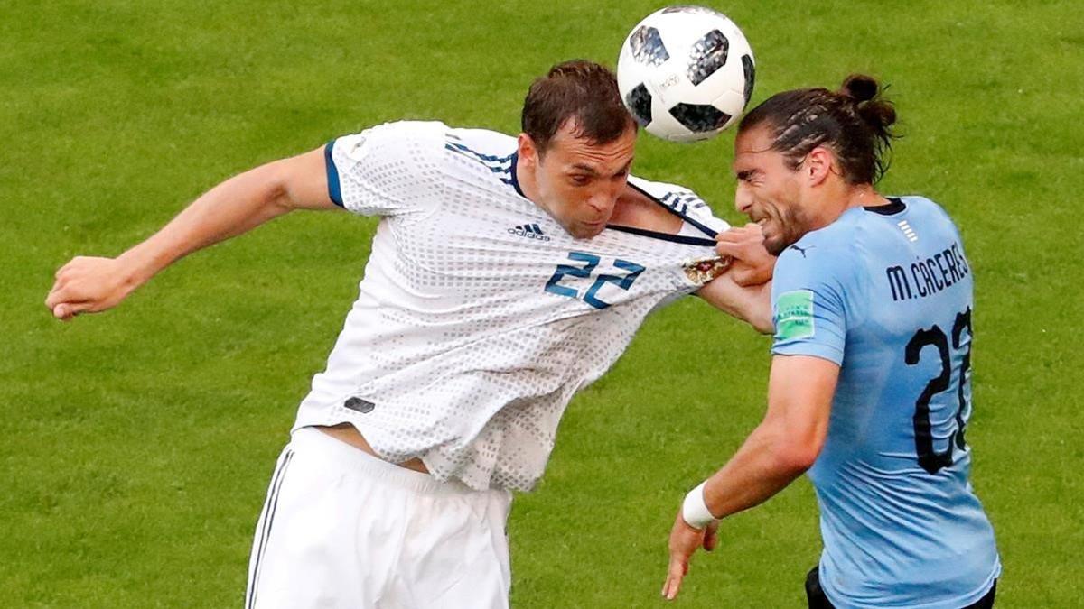 Artem Dzyuba in action with Uruguay s Martin Caceres