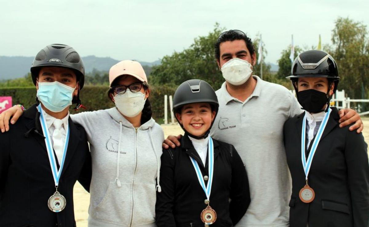 Carollo y Turnes posan con tres de sus alumnos.